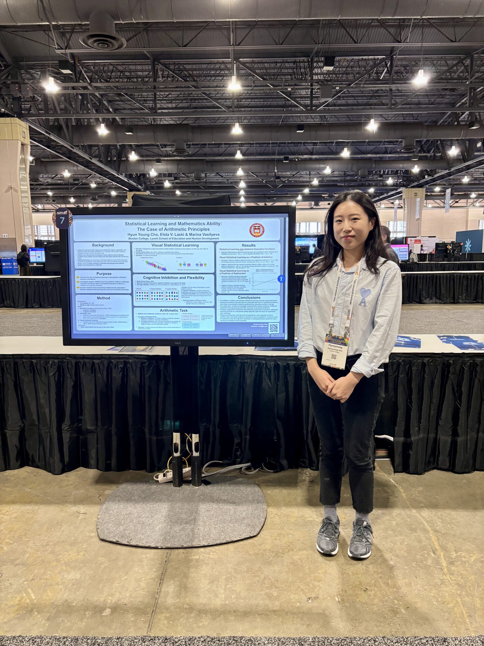 Katie presenting her poster at AERA (2024)